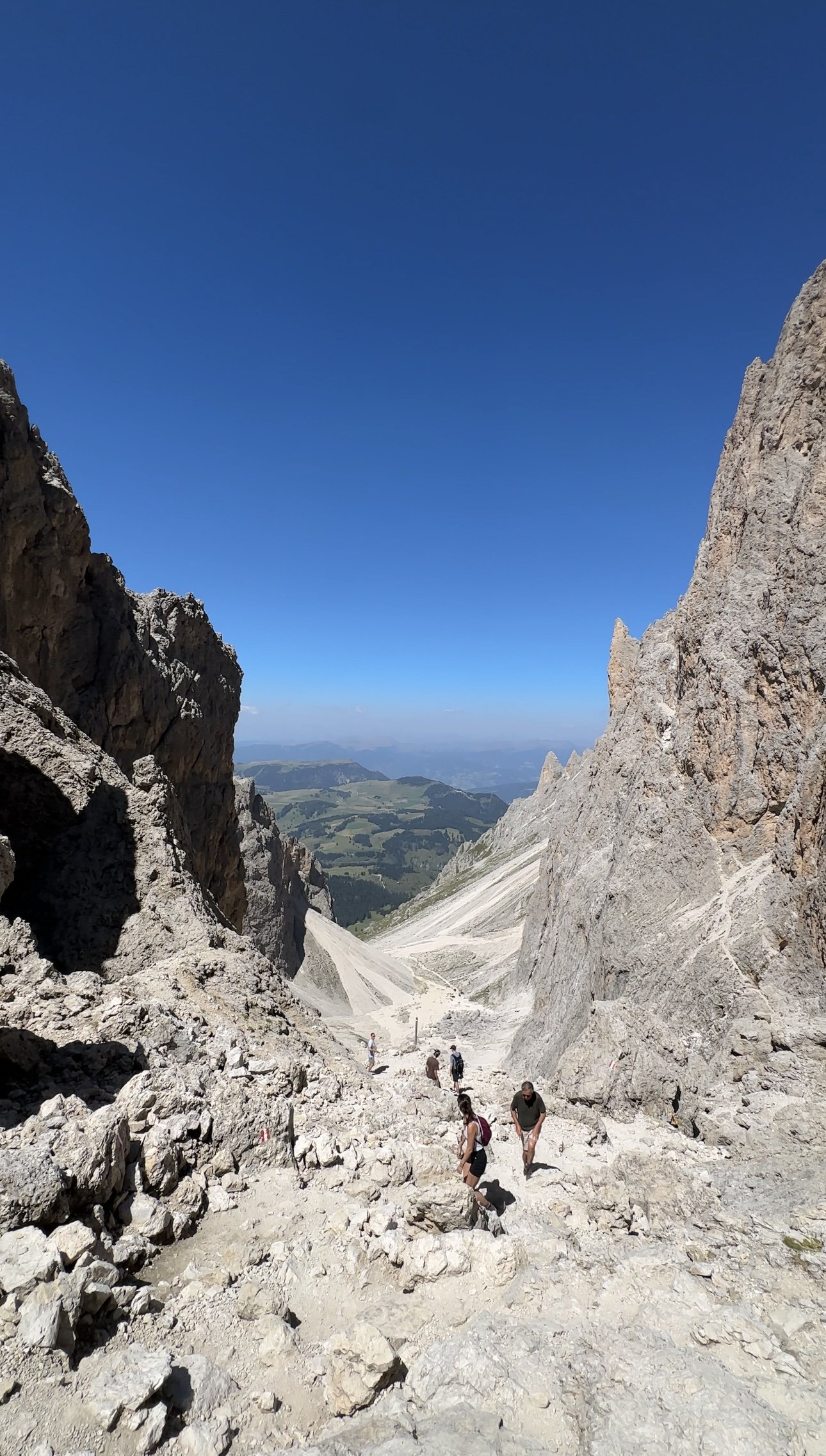 A group of hikers descending a rocky mountain pass together